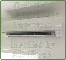 A split system air conditioner unit mounted on an exterior wall of a residential property in Brisbane.
