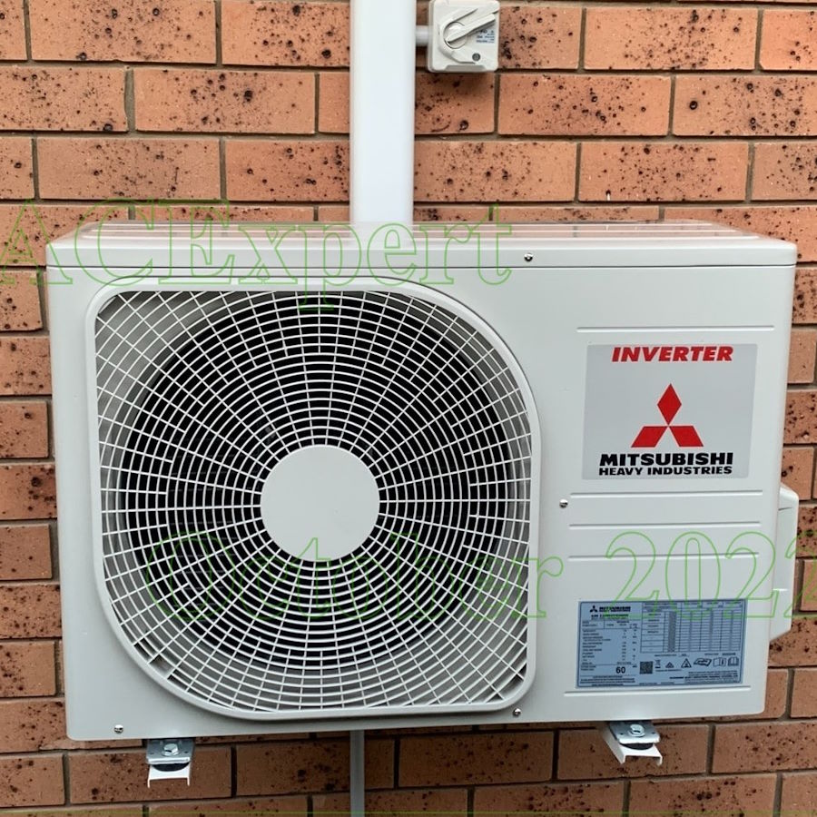 Service technician checking pressure gauges on an inverter heat pump for winter maintenance in Melbourne